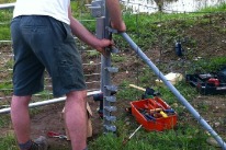 Mann repariert einen Drahtzaun im Rahmen der gemeinützigen Arbeit.